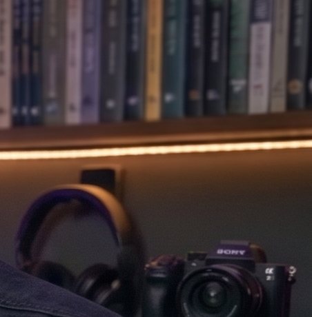 Bookshelf, headphones and camera on tripod